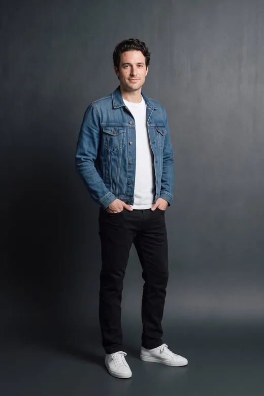 A look: tailored coat and grey trousers.