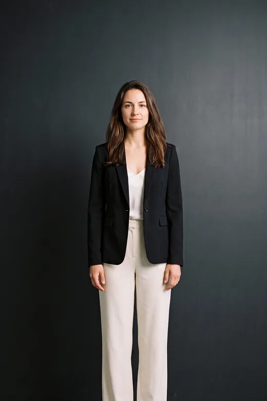A look: black blazer and cream trousers.